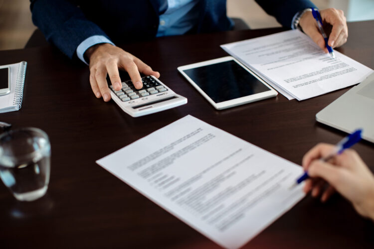 Close-up of financial consultant going through paperwork