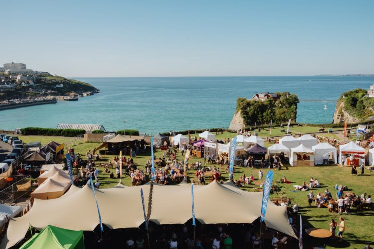 People gathered on the Killacourt where there are gazebos selling street food.